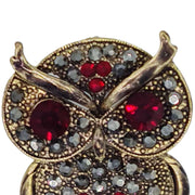 Broche buho colgante de metal dorado y brillantes de strass en color rojo. Trasera en color oro viejo con alfiler y seguro. Además del alfiler habitual, lleva una pieza que permite usarlo como colgante. Mide 6 cm de largo x 3 cm de ancho.