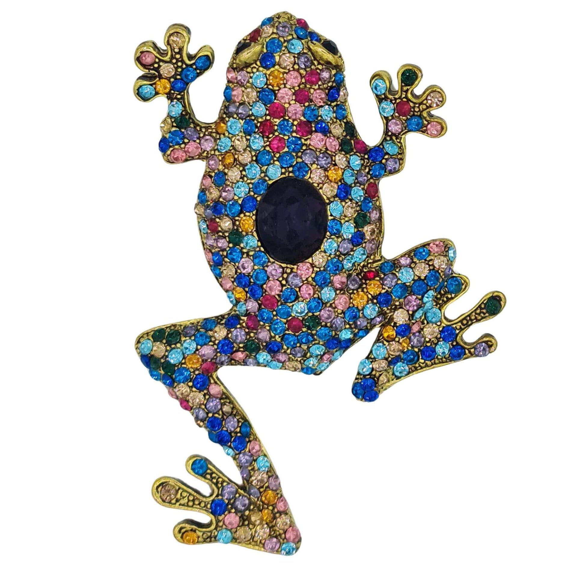 Broche rana colgante de metal dorado y brillantes de strass multicolor. Trasera en color oro viejo con alfiler y seguro.
Puede usarse también como colgante con una cadena ya que lleva una argolla en la parte superior. Mide 8 cm de largo x 5 cm de ancho.